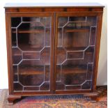 20th century mahogany bookcase of George III style with octagonal astragal glazed doors, 104cm wide,