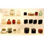 Collection of inkwells, some in leather cases.