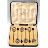 Cased set of six silver coffee spoons with bean terminals.