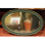 Early 20th century oval wall mirror, 88cm long.