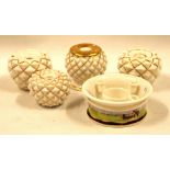 Four gilt porcelain inkwells and a circular inkwell.