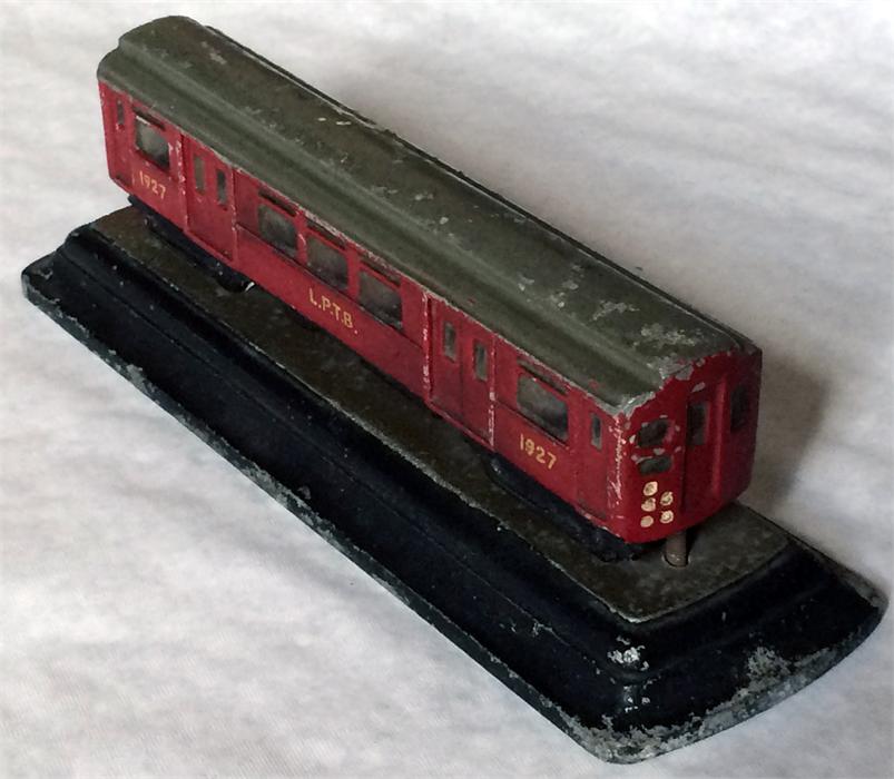 A 1930s alloy MODEL of a London Underground Q27-stock driving motor-car mounted on a plinth. The car