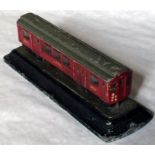 A 1930s alloy MODEL of a London Underground Q27-stock driving motor-car mounted on a plinth. The car