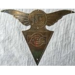 A brass AEC TRIANGLE BADGE surmounted by wings and