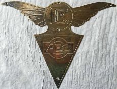 A brass AEC TRIANGLE BADGE surmounted by wings and