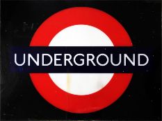 A perspex "Underground" bullseye sign, red circle with blue bar, designed to be back-lit and