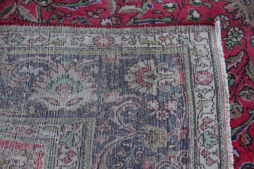 A Tabriz hand woven wool carpet, worked with an all over foliate design against a blue ground, - Image 3 of 3
