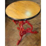 A cast iron pub table, with circular top on a tri-form scroll base,