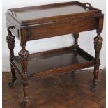 A 1920's oak two tier trolly, with detachable tray top and 17th century style baluster uprights,