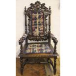 A Victorian carved mahogany hall chair, the back decorated with two lions and acanthus leaves,