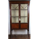 An Edwardian mahogany display cabinet, with two astragal glazed doors, on moulded and splayed legs,