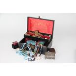 A jewellery case containing a collection of costume jewellery, assorted beads, necklaces,