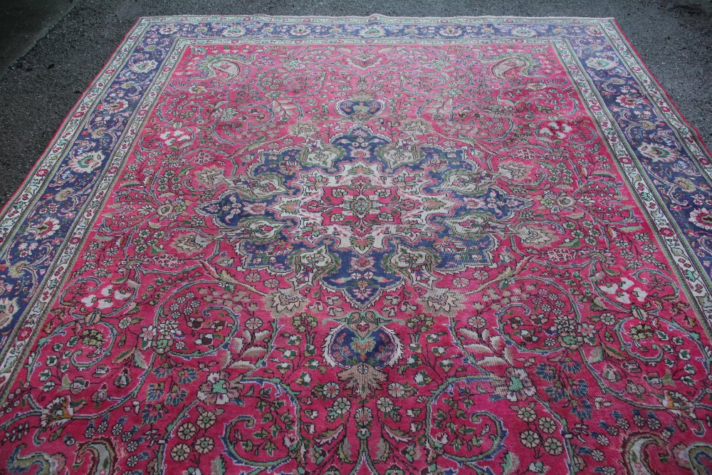 A Tabriz hand woven wool carpet, worked with an all over foliate design against a blue ground, - Image 2 of 3