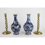 A pair of Chinese blue and white vases, decorated with prunus flowers, 30cm,