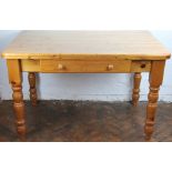 A modern pine dining table, on turned legs, 78cm H x 122cm W x 77cm D,