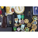 A collection of twenty three Masonic badges and medals, including two silver gilt examples,