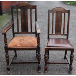 A set of six 1920's carved oak dining chairs, with arched backs and rexine seats,