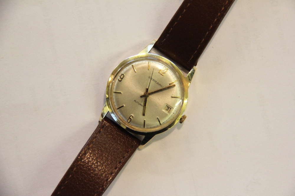 A Garrard's Automatic 9ct gold wrist watch, with Arabic and baton dial,