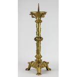 A 19th century French gilt metal pricket altar stick, on triform base,