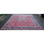 A Tabriz hand woven wool carpet, worked with an all over foliate design against a blue ground,