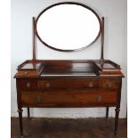 An Edwardian mahogany dressing table, with oval mirror above an arrangement of six drawers,