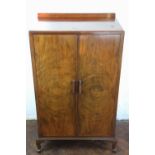 A 1930's walnut two door cabinet, on cabriole legs,