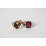 A garnet set signet ring, stamped '9ct' and another red stone set ring, indistinctly stamped '14k',