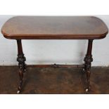 A Victorian inlaid burr walnut stretcher table, on turned and carved legs with fitted castors,