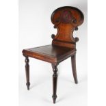 An early Victorian carved oak hall chair,