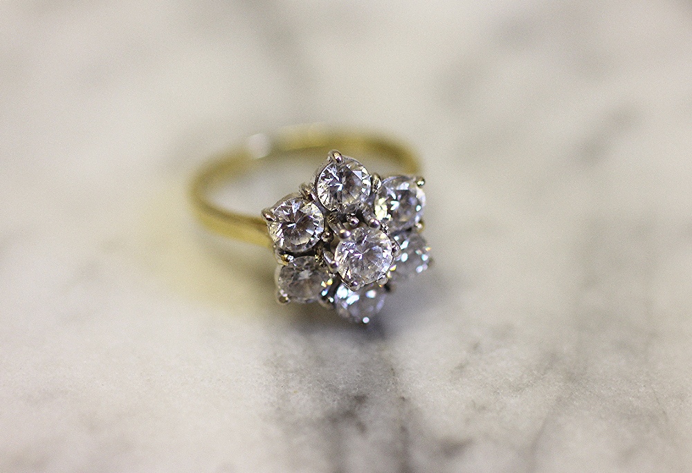A seven stone diamond cluster ring,