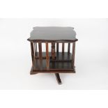 An Edwardian stained pine and poker work table top revolving bookcase,