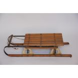 A vintage beech and metal sledge,