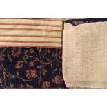 An assortment of upholstery fabric, various patterns, in a twin handled basket,