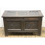 A late 17th century oak coffer, with three plank top and double panel front, on moulded stile feet,