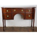 A George III style mahogany sideboard, with an arrangement of three drawers and a cupboard door,