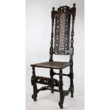 A late 17th century Carolean carved oak chair, the pierced foliate back with turned uprights,