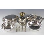 A collection of plated items, to include a toast rack, entree dishes,