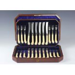 A cased set of twelve silver and ivory handled fruit knives and forks, James Dixon and Sons,