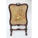 A Victorian carved mahogany fire screen,