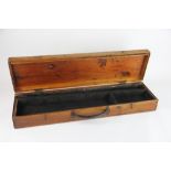 A pine gun case, with compartmented interior and leather handle,