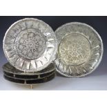A set of eight Indian white metal circular serving dishes, four larger and four smaller,