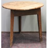 A George III oak cricket table, with three plank circular top, on triangular legs,
