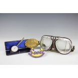 A pair of vintage leather and painted metal motorcycle goggles, a Scoll Owners Club enamel badge,