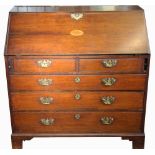 A George III mahogany bureau, with inlaid fall enclosing a fitted interior,