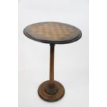 A Victorian inlaid walnut games table, with chessboard inset circular top,