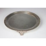 A Sheffield plate waiter, the gadrooned rim with three floral bracket feet,