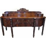 A George IV carved mahogany sideboard, the raised two tier back with two bow front drawers,