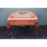 A Victorian carved mahogany stool, with tapestry seat on cabriole legs,