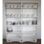 A modern white painted open bookcase, with moulded cornice above adjustable shelves,