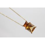 A citrine set pendant, designed as a square set citrine, with rectangular cut citrine surmount,